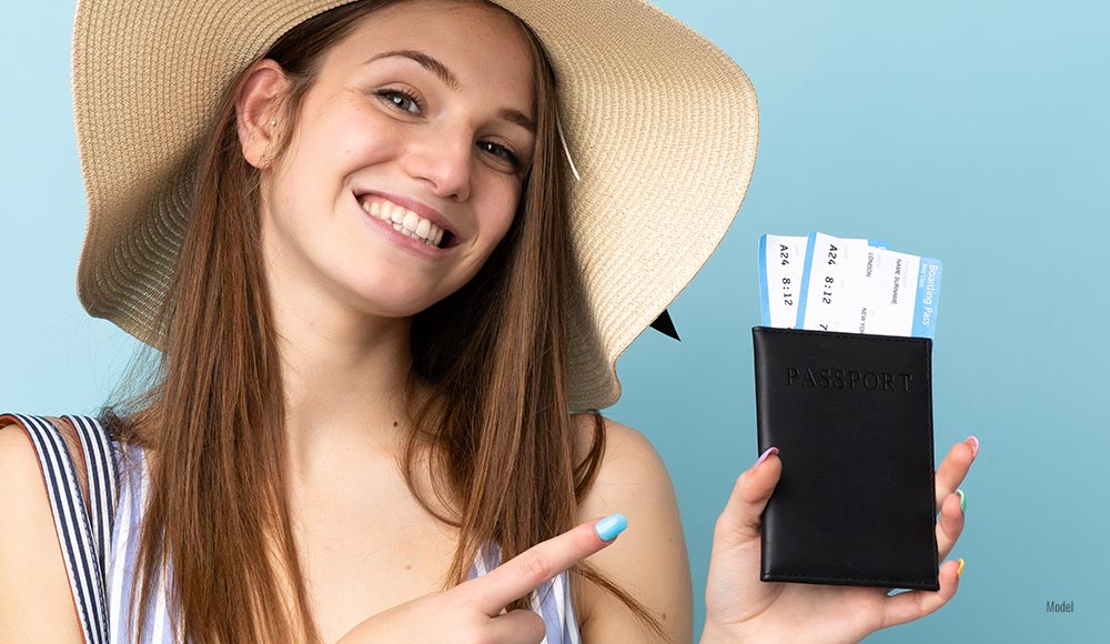 Female holding passport in one hand